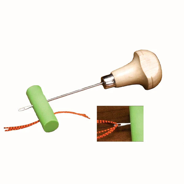 Hareline Zuddy's Leg Puller featuring a wooden ergonomic handle, stainless steel shaft, and green foam grip, designed for securely pulling and threading fishing tackle line.