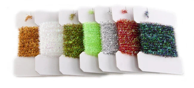 Wapsi Tinsel Chenille in various colors including gold, white, green, chartreuse, silver, red, and blue, displayed on white cards for use in fly fishing and fishing tackle crafting.
